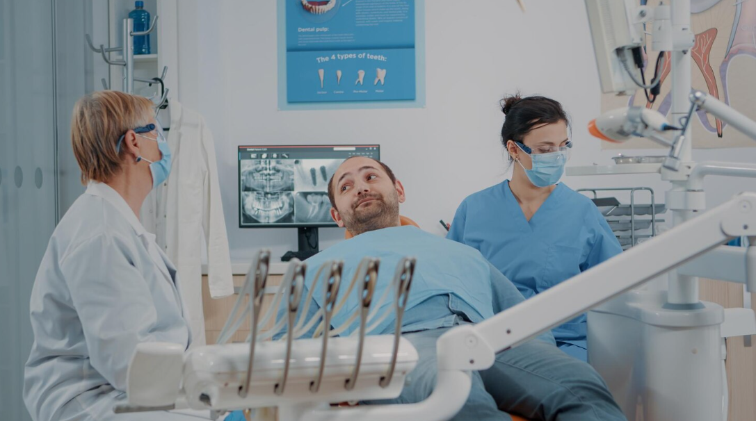 Dentist performing oral surgery